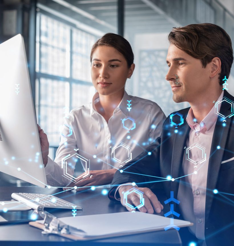 Businessman and businesswoman in formal wear working together to optimize business process by applying new technologies. Hi tech holograms over modern office background with panoramic windows